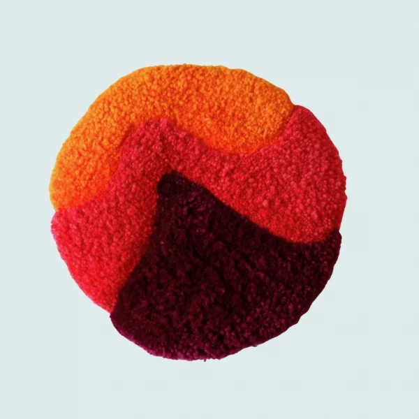 Photo de Woogie, décoration murale tuftée. Laine acrylique dans les tons pourpre, orange et rouge.